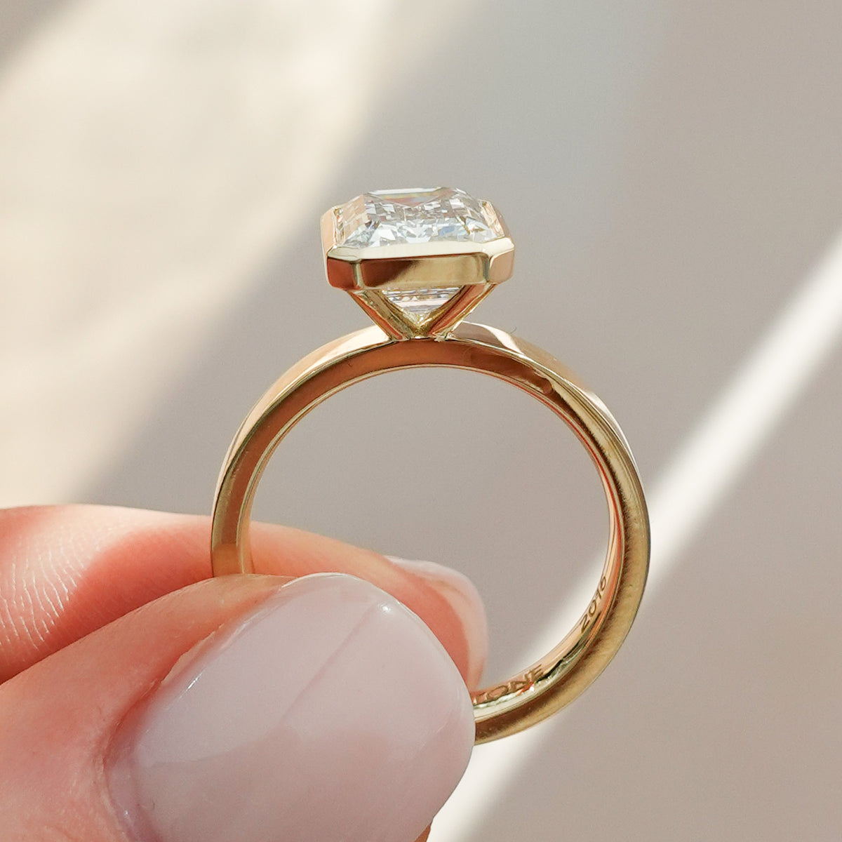 Finest Bezel Set Engagement Ring With Emerald Cut Diamond