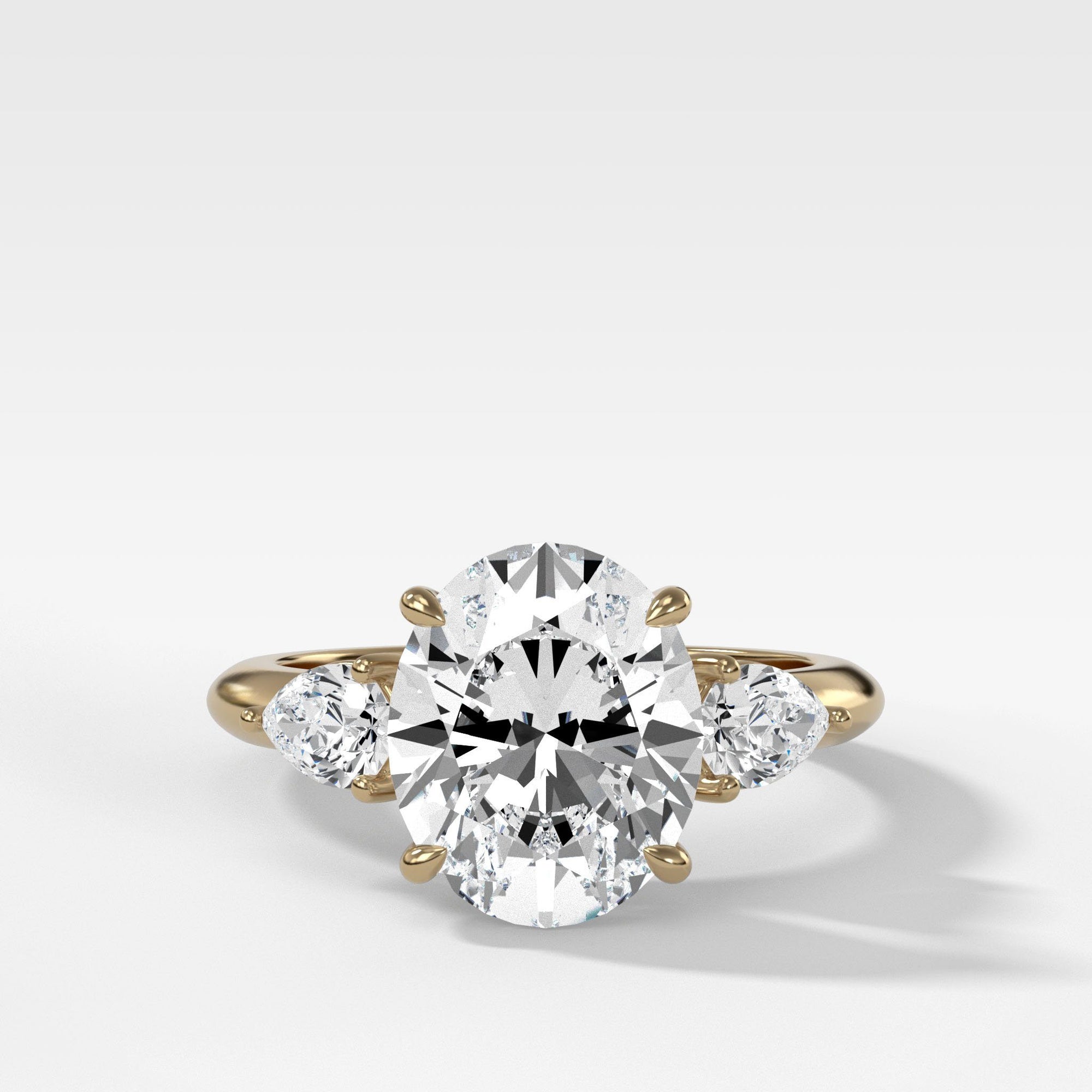 Three Stone Engagement Ring With Pear Side Stones and Oval Cut Diamond ...
